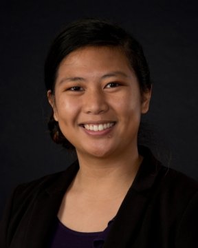 Nurse practitioner smiling and wearing a black shirt.